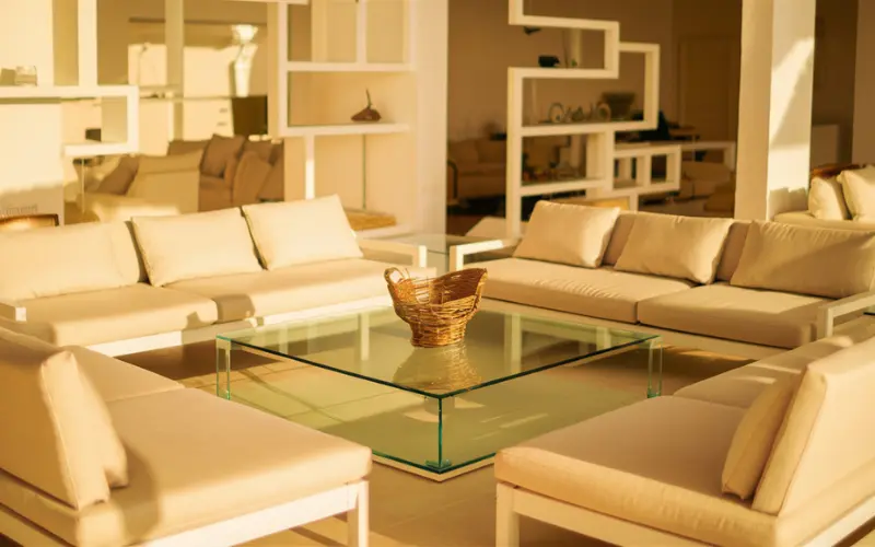 A well-organized living room with furniture arranged to allow sunlight to flow freely.