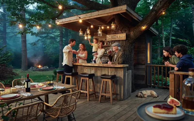 Stylish backyard treehouse bar with wooden counter.